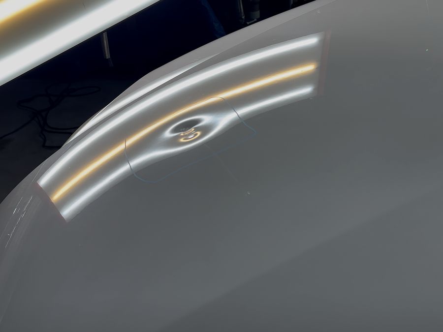 Overstretched dent on a hood before paintless dent repair
